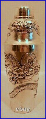 A Chinese Export sterling cocktail shaker, repousse dragons, sun, signed