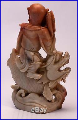 Antique Chinese soapstone carving Immortal riding dragon fish holding peach, fan